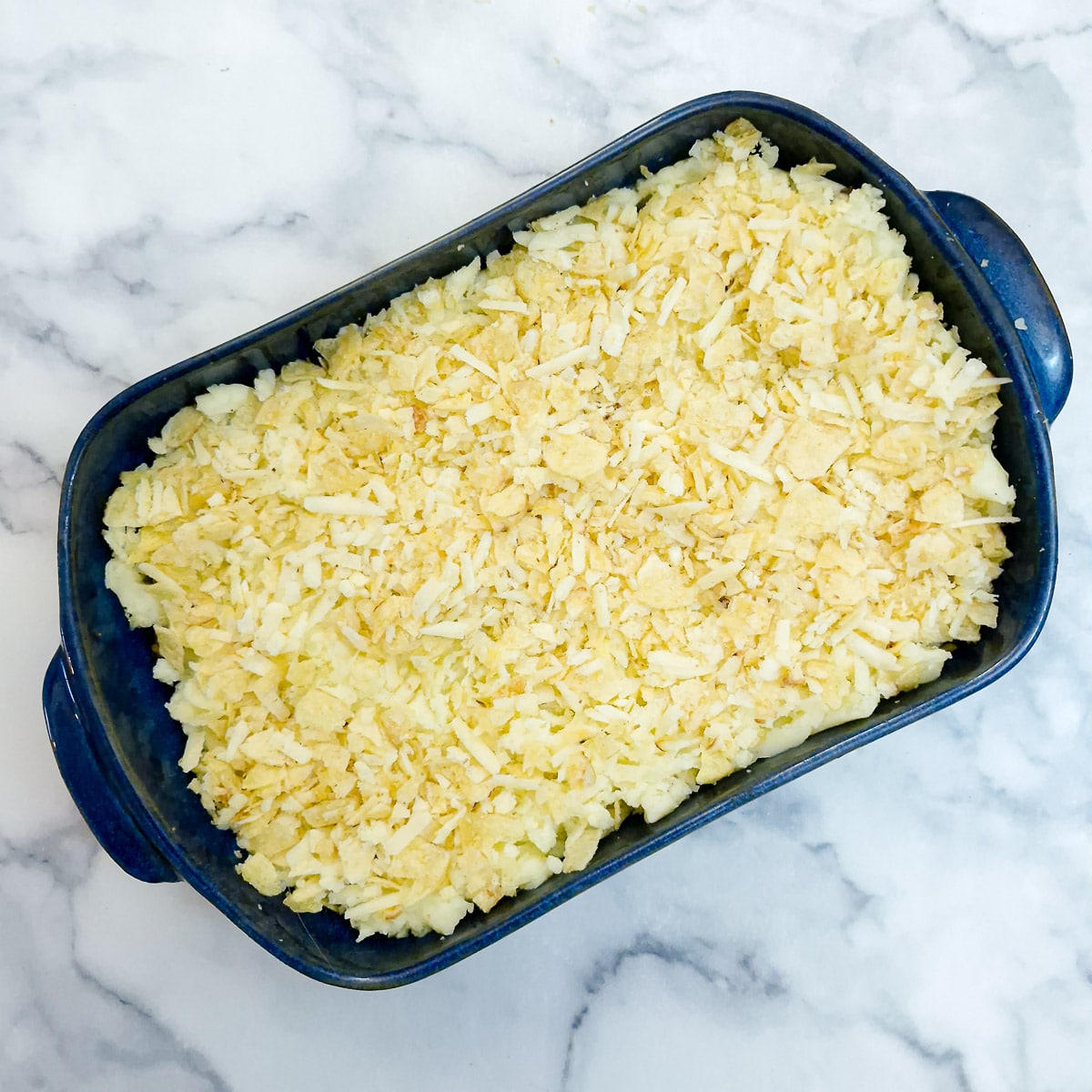 Step 11 - the mashed potato spread over the mince and topped with the chese and crisps mixture.