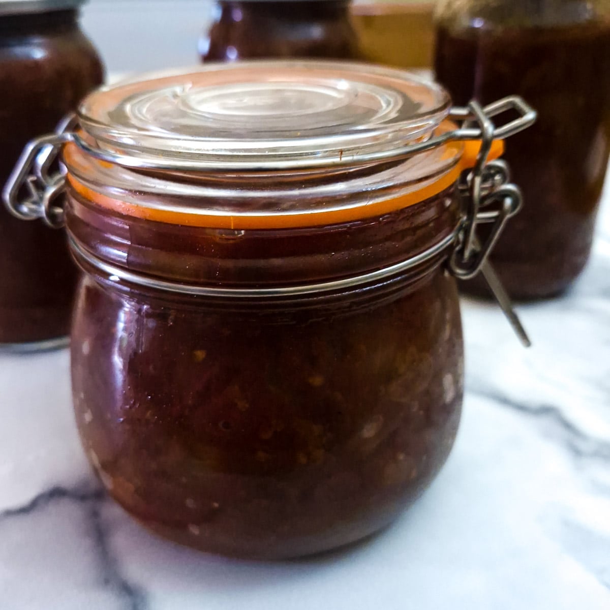A sealed jar of fruity tomato chutney.