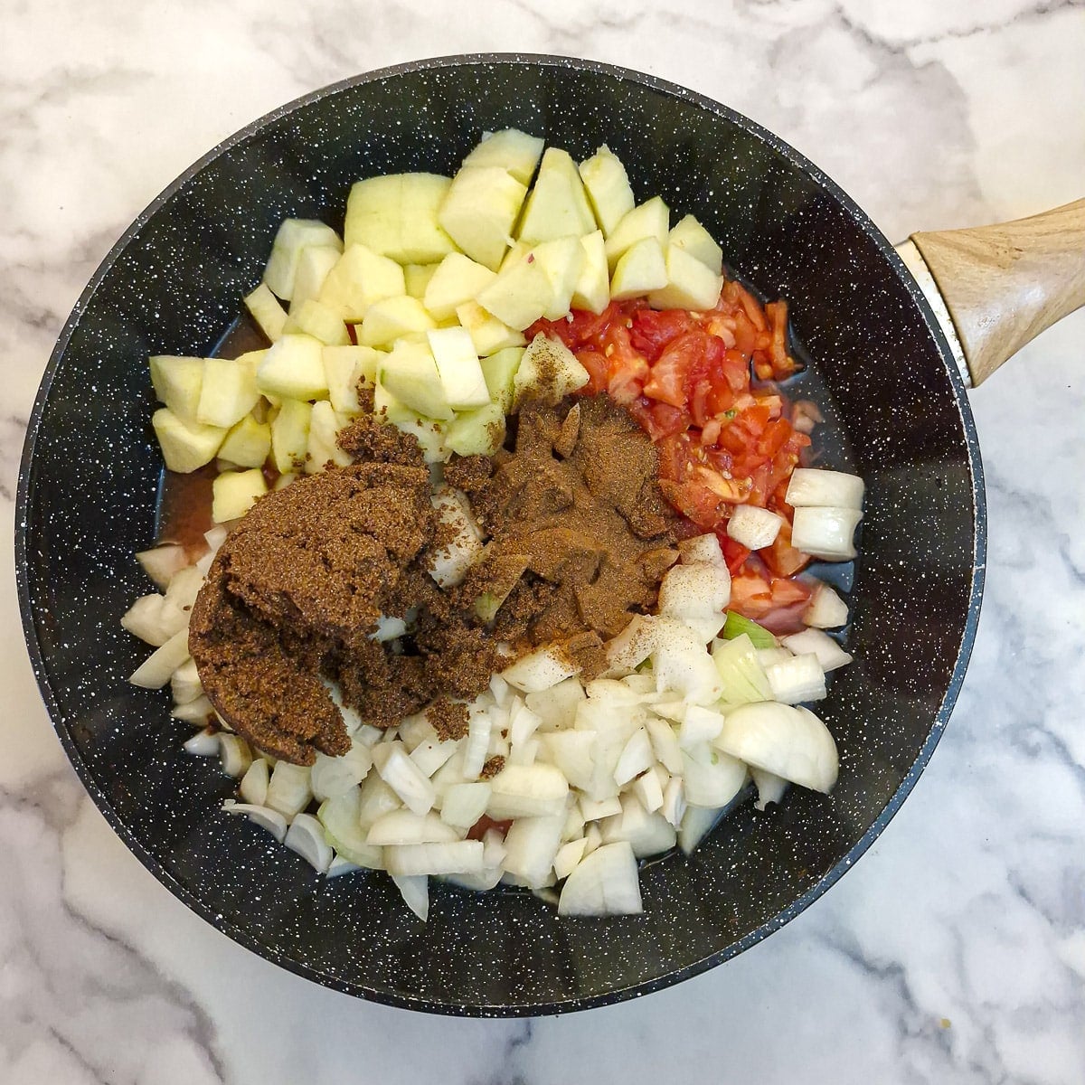 Step 1 - ingredients for tomato chutney placed in a large wok.
